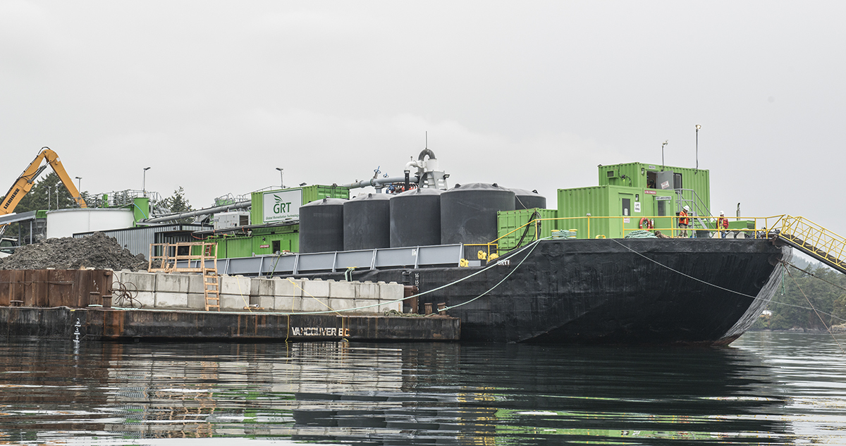 Dredged materials are processed by this barge-mounted treatment plant including UXO removal, materials cleaned and sorted and treated water returned to the ocean.