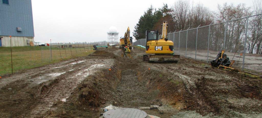 During construction, crews battle rain as they create swales to collect and redirect rainwater.